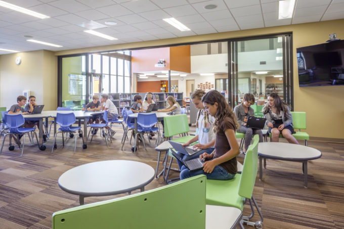 Sliding glass doors to open or close off education spaces can combine with classroom furniture innovations for a flexible space